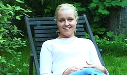 Blue-eyed blonde is getting naked in the green garden