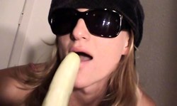 Beautiful amateur girl with nice face is sucking a big banana