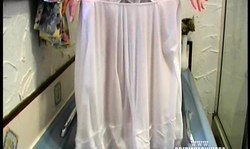 Golden blonde in white dress takes a bath and slowly undress