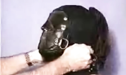 Perverted master is covering his slave's face with a mask