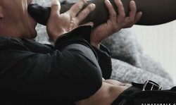 Black stockings blonde gives him a footjob on a couch