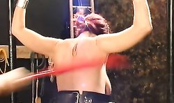 Spanked redhead lady in leather belts is getting whipped in the dungeon