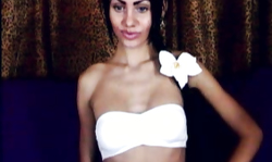 Fake-tit brunette is dancing and showing off her tight pussy