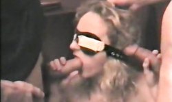 Slender busty goddess is sucking three gangbang dicks on the camera