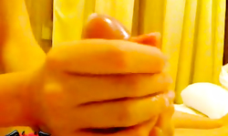 Amateur beauty is wanking a hard dick in the bedroom