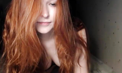 Russian redhead babe demonstrates her massive tits!