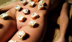 All-natural naked Russian beauty used as a table for the sushi