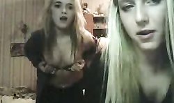 Two playful Russian chicks are kissing and playing in the kitchen