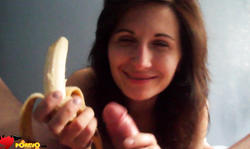 Dark-haired woman is eating banana and blowing a dick