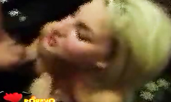 Dirty blonde is blowing two hard cocks in the rented room