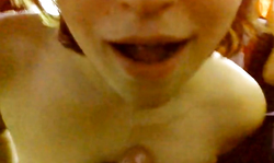 Smiling redhead chick is blowing a hard cock in the close-up