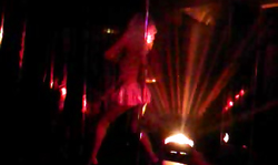 Elegant long-legged girl is dancing in miniskirt in the night club