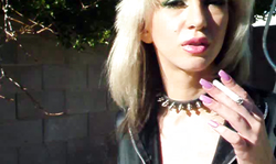 Fake-tit milf is lying topless and smoking a cigarette