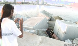 Busty brunette sucking cock on dock