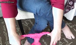 Beautiful amateur MILF shows her cute pink undies on the sofa