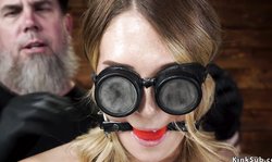 Blonde slave in suspension is whipped