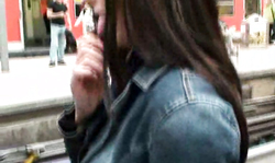 Nerdy girl with short skirt showing her booty with anal toy on public