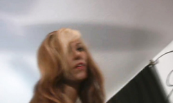 Big-tit blonde in pantyhose is getting naked in a spicy way