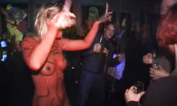 Awesome busty babe with red body paint goes nude on public