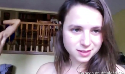 Pretty young girlfriend smiling while sucking his loaded dong