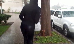 Sweet spandex brunette is walking on the street in a hot way