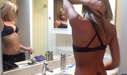 Sweet golden blonde is taking off Spandex pants in the bathroom