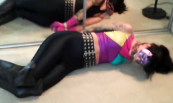 Sexiest bitch in black spandex tights is lying while being bonded