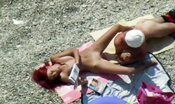 Sexy-shaped redhead babe is getting her pussy licked on the beach