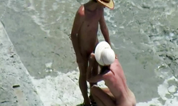 Sweet slim brunette with long legs is giving an outdoor blowjob