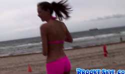 Sporty Brooke Skye poses on the beach in bright pink bikinis