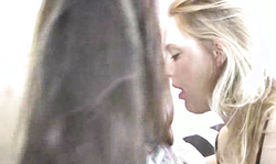 Blonde, brunette and redhead are kissing on the striped couch