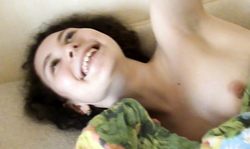 Adorable Russian brunette with curly hairs is getting topless