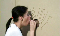 Black-haired kinky babe gives a blowjob in the gloryhole