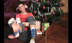 Kinky gf is lying by X-Mas tree and showing her accurate soles