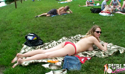 Hot cutie slowly undresses on the grass and asks a stranger to apply tan cream