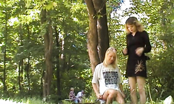 Two awesome-looking leggy chicks are kissing and masturbating on public