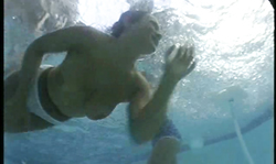 Four leggy babes in white dresses are getting topless underwater