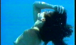 Slender black-haired diver shows off her body underwater