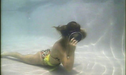 Extremely horny babe is posing topless underwater