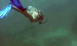 Underwater solo featuring a long-legged diver with cute round tits