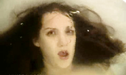 Dark-haired cougar with red lips masturbates Underwater