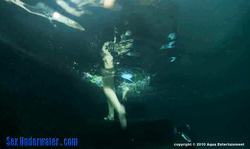 Brunette gives a good underwater blowjob in the mask