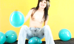 Topless brunette in tight jeans is jumping on her lovely blue balloon
