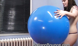 Smiling big-boobed MILF jumps on a big red balloon
