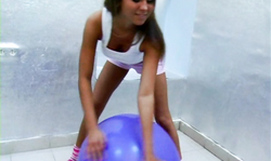Elegant and athletic girl is playing with a purple balloon
