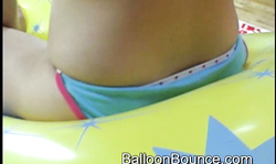 Bleached babe with pierced nipples plays with a yellow balloon