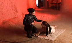 Stunning BDSM Domme in black leather and her submissive girl