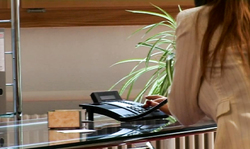 Office beauty on black high heels poses in a hot way