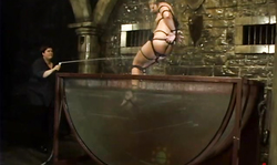 Gagged Vendetta is trying water tortures in the dungeon