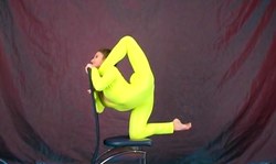 Sweet young beauty in yellow latex suit demonstrates weird poses